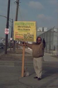 Wayne Strnad holding picket sign telling people to call Devine